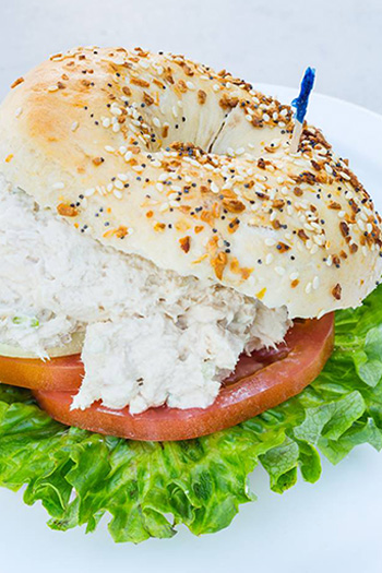 bagel with tomatoes, lettuce, and shmear